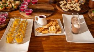 南圣胡安Casa Oro Eco Hostel的一张桌子,上面放着两盘白盘的食物和饮料