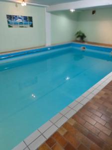 豪恩斯泰因Landhotel Neding的客房内的大型游泳池,有蓝色的水