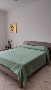 新福卡Appartamento Eurogarden的卧室内的一张带绿色棉被的床