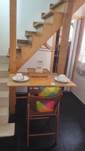 塔兰托the lighthouse accommodation的一张木桌,桌子上摆放着椅子,桌子上摆放着盘子