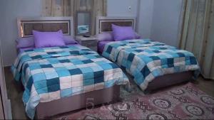 Kafr ʼakīmLoulouat Al Reef的卧室内两张并排的床