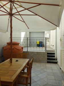 雷焦卡拉布里亚Arte Mia B&B的庭院配有桌椅和遮阳伞。