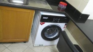 迪拜Ruby Star Male Hostel Dubai的厨房的柜台旁设有洗衣机