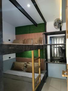 碧瑶Holyghost Veranda Baguio Transient Guest House 42 step rooftop的配有绿色墙壁的客房内的双层床
