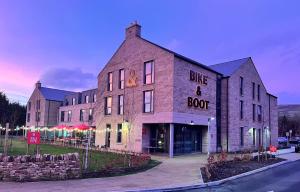 卡斯尔顿Bike & Boot Inns Peak District - Leisure Hotels for Now的蓝色和根的砖砌大建筑