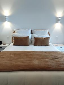 PublierAu coucher du lac的卧室配有一张带白色床单和枕头的大床。