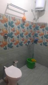 比纳里姆D 'SOUZA HOLIDAY HOME的一间带卫生间的浴室和花卉壁纸