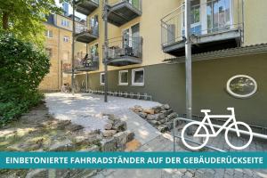 拜罗伊特Apt Wahnfried Nr1 - Cityapartment mit Küche, Duschbad, Balkon, Parkplatz - zentral aber ruhig的停在大楼旁边的一辆白色自行车