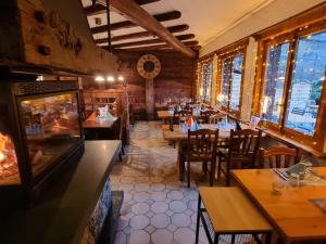 奥西耶尔Le Catogne的一间带桌椅和壁炉的餐厅