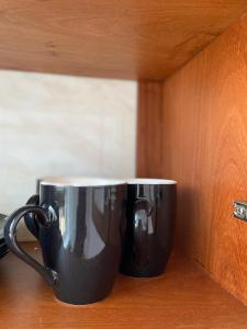 LuisiLuckysmallie_villa的两个黑咖啡杯坐在柜台上