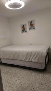 阿列塔2 bedrooms appartement at Arrieta 300 m away from the beach with furnished terrace and wifi的卧室配有一张墙上有两张照片的床。