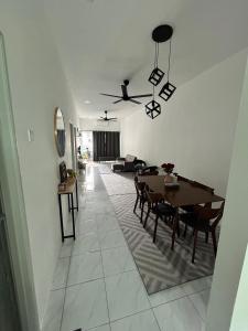 卢穆特Zh homestay teluk batik的用餐室以及带桌椅的起居室。