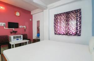 KahalgaonHotel Nilay & Banquet (Vivah Bhawan)的卧室配有白色的床和红色的墙壁