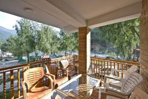 马拉里Hotel Himalayan Classic, Manali的阳台配有椅子,享有街道的景色