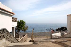 坎德拉里亚Casa Fefa的拥有建筑和海洋的海滩