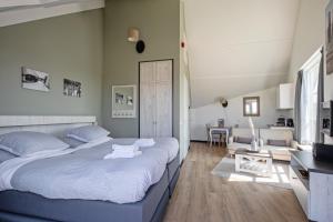德科赫Strandplevier Suites的一间带大床的卧室和一间客厅