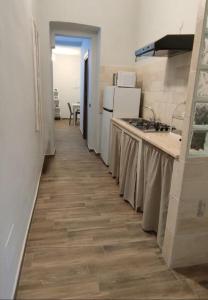塔兰托Casa Principe Taranto "Intero appartamento"的走廊上设有带柜台和炉灶的厨房