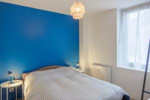 奥尔良Maison rénovée-moderne avec cour à 2 pas du centre的一间卧室设有蓝色的墙壁和一张床