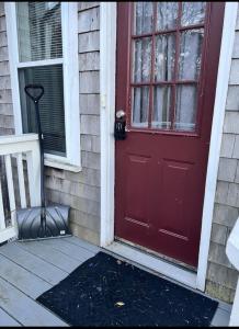 法尔茅斯Charming Cottage Historic Falmouth Cape Cod Near Beach and Downtown 2BR 1Bath Deck的房子边的红色门