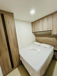 格拉瓦塔Flat Fazenda Monte Castelo Gravatá的卧室配有白色的床铺和木柜