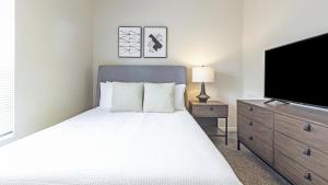 赫兰德Landing - Modern Apartment with Amazing Amenities (ID9894X86)的一间卧室配有一张床和一台平面电视