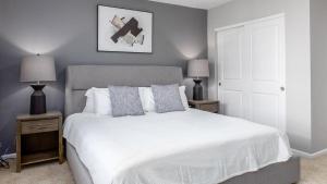 哥伦布Landing - Modern Apartment with Amazing Amenities (ID8193X50)的卧室配有一张白色床、两个床头柜和两盏灯。