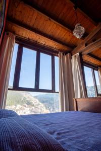 阿尔卡拉德尔胡卡尔Casa Rural Los Ventanales的一间卧室设有一张床和一个大窗户
