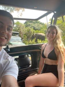 蒂瑟默哈拉默Yala Leisure Villa & Safari的坐在车后面的男人和女人,有大象