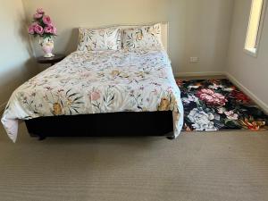 Clyde NorthStar Pavillon hide away的一间卧室配有一张带花卉床罩的床