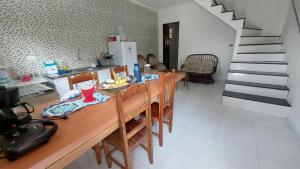 伊比科阿拉Residencial Maria de Lourdes的一间带木桌和椅子的厨房以及一间用餐室