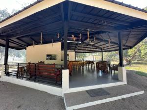 布桑加Magalong Villa at Holy Land in Busuanga的蓝色凉亭,在田野里配有桌椅