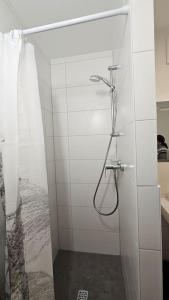 科隆Chillax Ferienhaus für Familie und Urlauber的白色墙壁上带淋浴的浴室