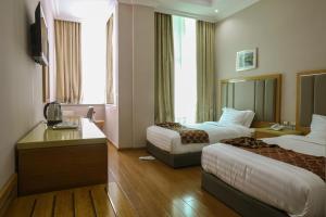 亚的斯亚贝巴New Day Hotel的酒店客房设有两张床和电视。
