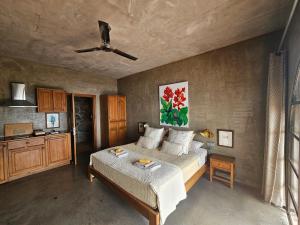 卡列塔Les Terrasses Suites的一间卧室配有一张床和吊扇