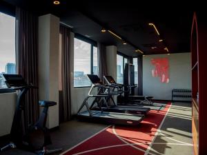 贝尔格莱德Radisson RED Belgrade的一间健身房,里面设有几台跑步机,房间设有窗户