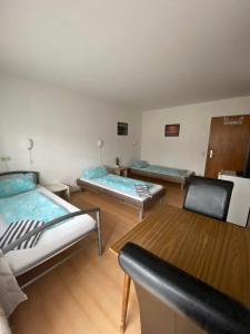 卡尔斯巴德Monteurzimmer - Karlsbad的一间设有两张床和两把椅子的房间