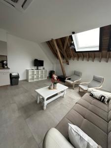 洛布Gîte du Fenil的客厅配有沙发和桌子