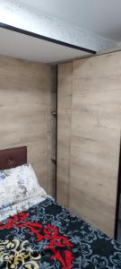 IhaddademStudio lea的木墙客房的一张床位