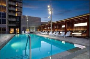 多伦多300 Front Suites - Two Beds with Free Parking的一座带白色椅子的大型游泳池