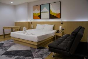 曼谷樱花天空公寓式酒店的一间卧室配有一张床和一张沙发