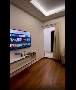 因帕尔Sunset Homes Imphal的客厅配有壁挂式大屏幕平面电视