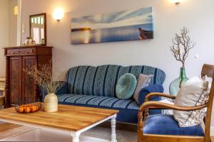 博尔库姆Commandeur-Huus Wohnung 1的客厅配有蓝色的沙发和桌子