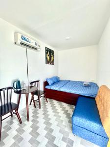 嘎那角Tân Thành Resort的一间卧室配有一张床、一张桌子和一张沙发