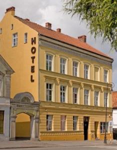 巴尔托希采SHotels przy Restauracji Stodoła的黄色的建筑,旁边标有标志
