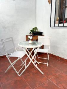 萨尔塔La Casita Amarilla en Salta的两把椅子和一张桌子以及一张桌子和椅子