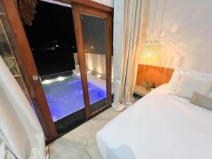 贝贝里比Jurema Dourada的一间卧室设有一张床和一个带游泳池的窗户
