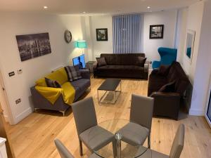 伦敦Dockland Excel 2 Bedroom Apartment的带沙发、椅子和桌子的客厅