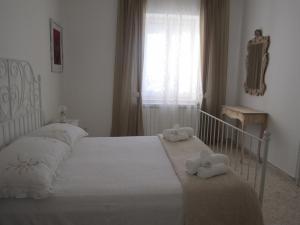 阿尔贝罗贝洛Welcome to Alberobello的卧室配有白色床和毛巾