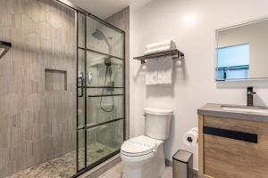 洛杉矶Hotel Koxie的一间带卫生间和玻璃淋浴间的浴室