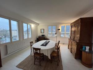 昂热Appartement château Angers 147 m²的一间带桌椅和窗户的用餐室